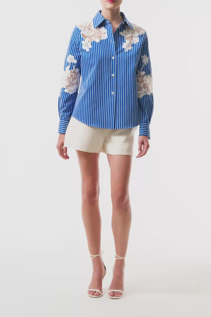 Monique Lhuillier Spring 2025 Long sleeve, button front collared striped shirt with lace detailing in Nautical Blue poplin with White lace details  - video.