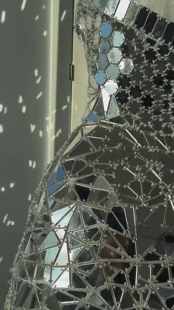 Monique Lhuillier Fall 2025 strapless mini dress in silver mirrored embroidery - detail reel from Instagram.