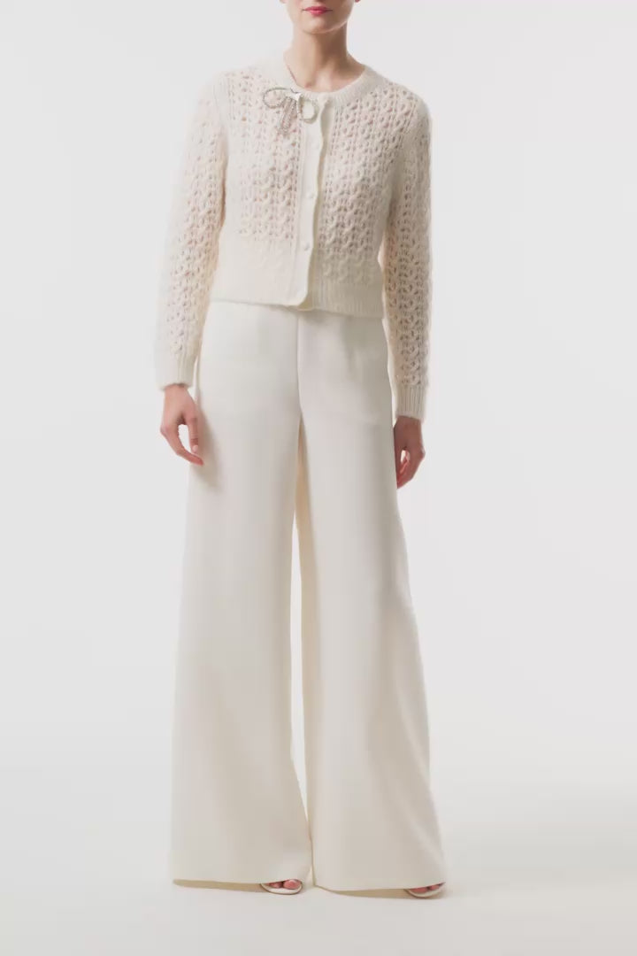 Monique Lhuillier Fall 2025 Mohair Silk Cashmere cardigan with brooch and white wide leg trouser- video.