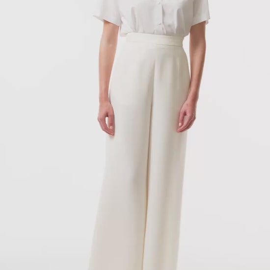 Collared, button-front short sleeve shirt in silk white poplin fabric with lace detailing at shoulders and back - video.