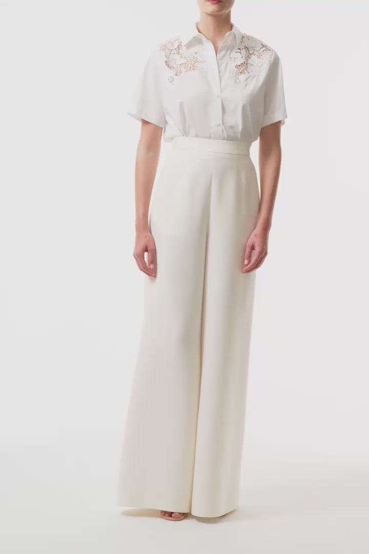 Collared, button-front short sleeve shirt in silk white poplin fabric with lace detailing at shoulders and back - video.