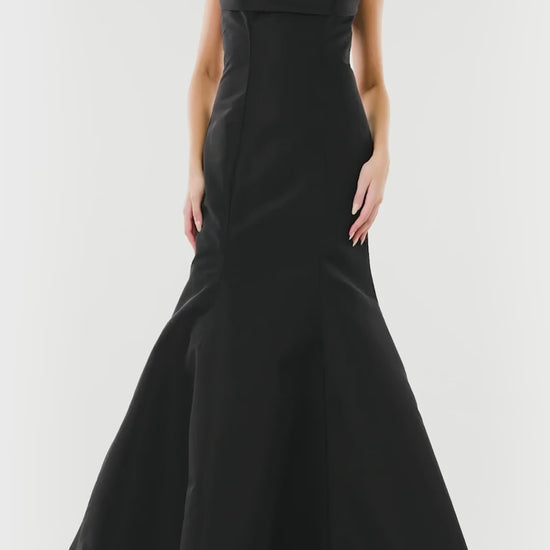 Monique Lhuillier noir strapless, faille evening gown with draped bodice and mermaid skirt.