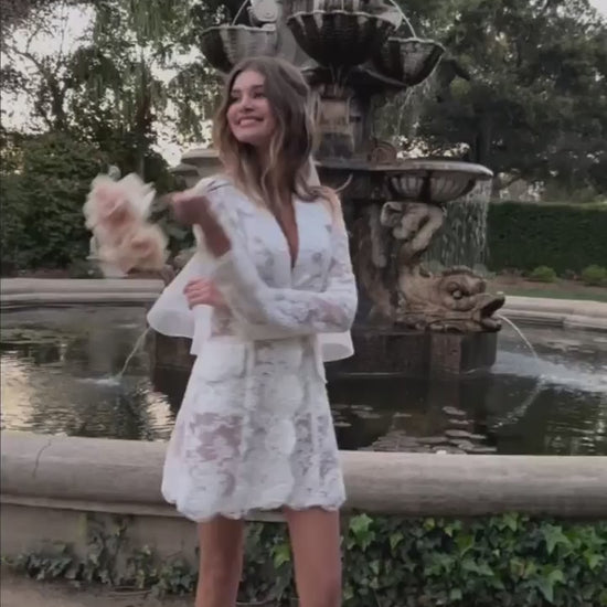 Video of model wearing the Claude Dress holding a floral bouquet