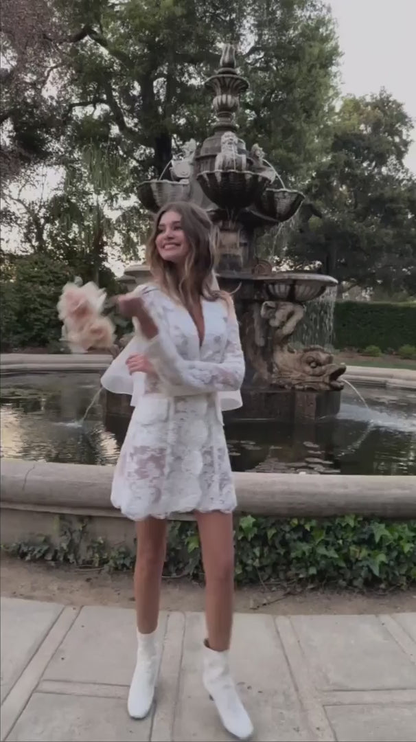 Video of model wearing the Claude Dress holding a floral bouquet