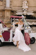 Woman wearing Monique Lhuillier Spring 2023 Bliss white lace sweetheart fitted trumpet BL23101 gown with matching lace opera-length gloves